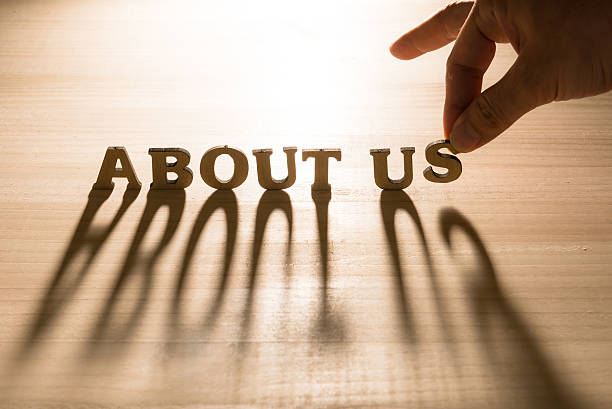 wooden words about us putting by hand and the shadow